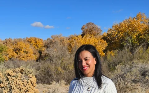 Gal Manning outdoors in Rio Rancho with golden autumn trees behind her.